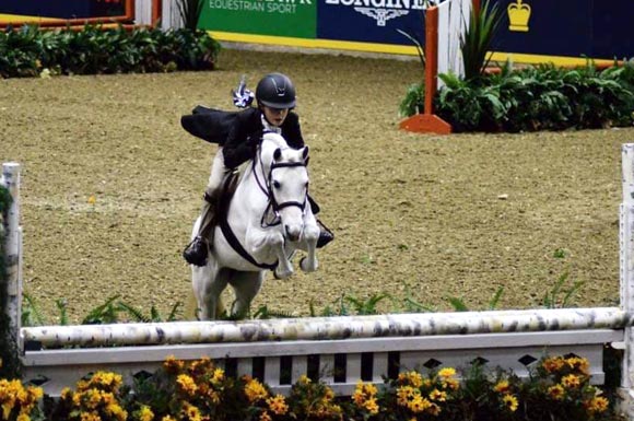 Kailey Kaiser and Northwind Snow Angel competing in a Hunter Jumper class at the Royal